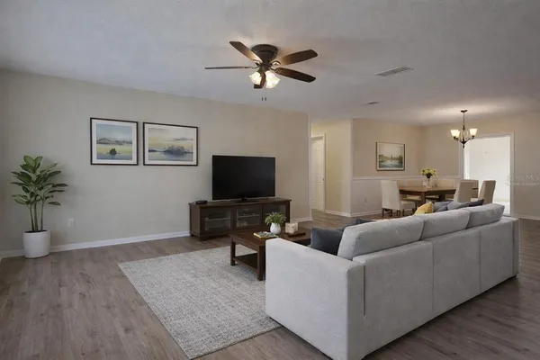 a living room with furniture and a chandelier