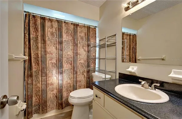 a living room with a bed furniture and a window