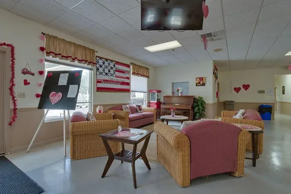 a room with pool table and window