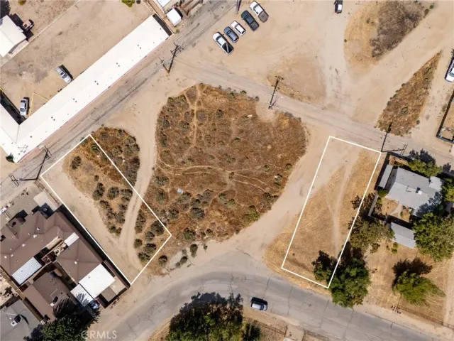 an aerial view of a house a yard and mountain view in back