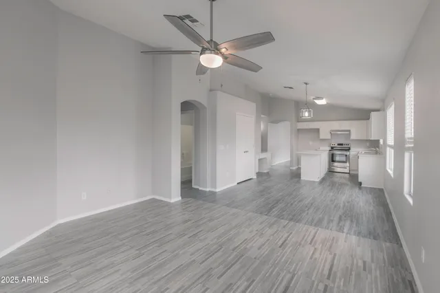 a view of a kitchen with a sink and wooden floor