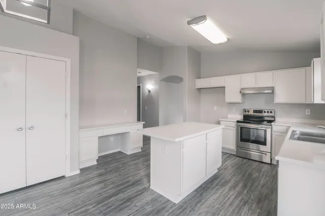 a kitchen with a stove a sink and a refrigerator