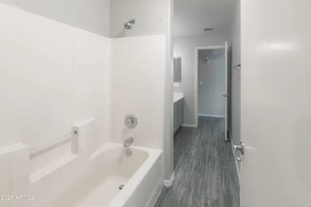 a bathroom with a bathtub and shower