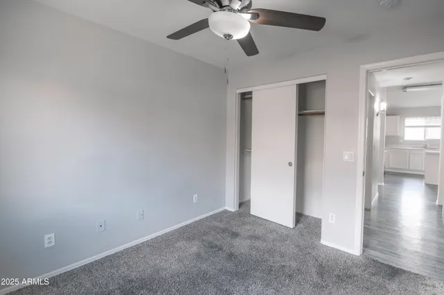 a view of a livingroom with a ceiling fan and window