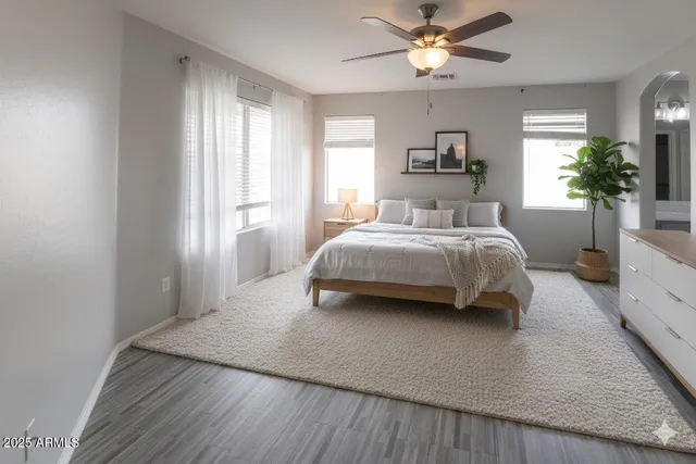 a spacious bedroom with a bed and a chandelier