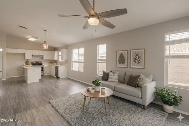 a living room with furniture and kitchen view