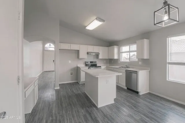 a kitchen with white cabinets and white appliances