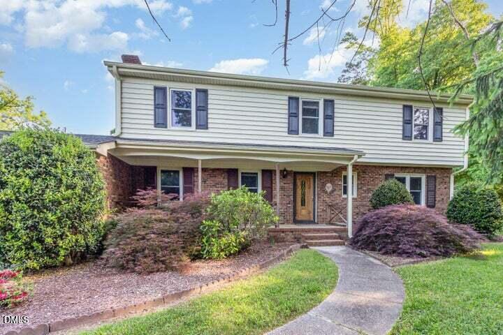 a front view of a house with garden and porch