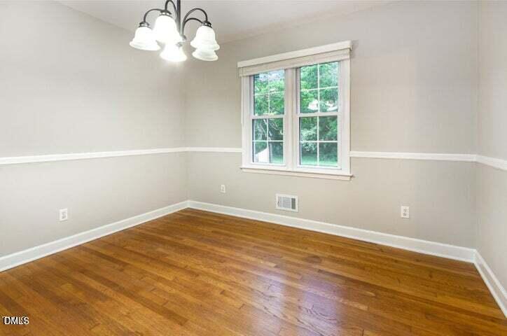 3209 Marie Drive Raleigh, NC 27604 - Photo 12 of 40 a view of an empty room with wooden floor and a window