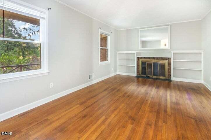 3209 Marie Drive Raleigh, NC 27604 - Photo 19 of 40 a view of an empty room with a window and wooden floor