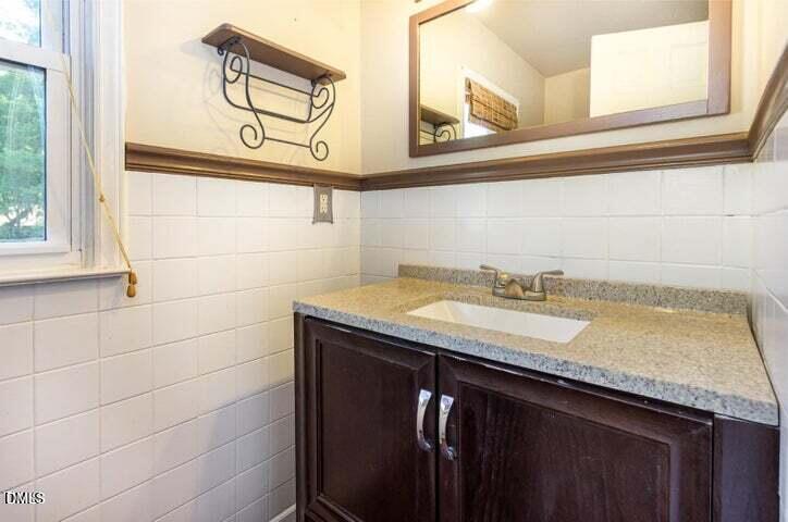 3209 Marie Drive Raleigh, NC 27604 - Photo 20 of 40 a bathroom with a granite countertop sink and a mirror
