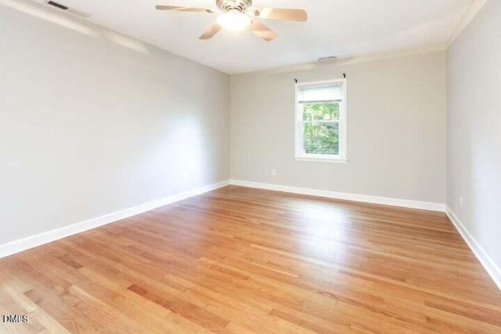 3209 Marie Drive Raleigh, NC 27604 - Photo 21 of 40 an empty room with wooden floor and windows