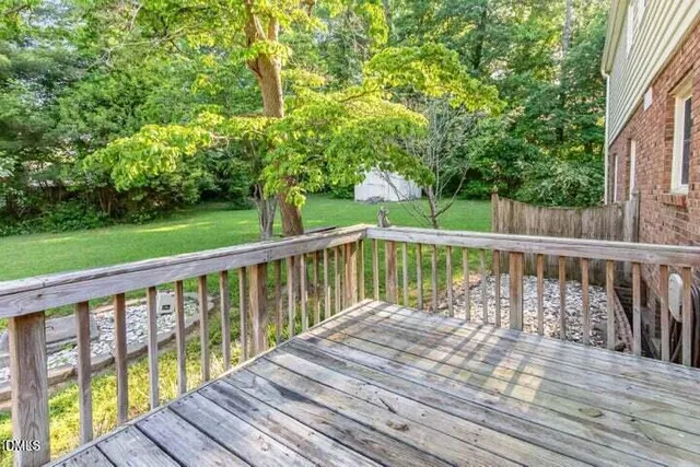 a view of balcony with wooden floor and fence