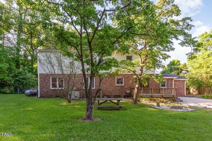 3209 Marie Drive Raleigh, NC 27604 - Photo 37 of 40 a view of a house with backyard and a tree