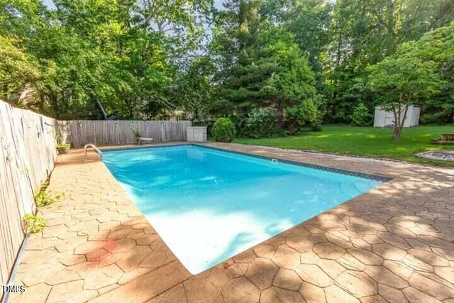 a view of swimming pool with a backyard