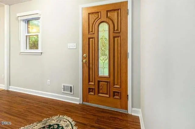 a view of front door with wooden floor
