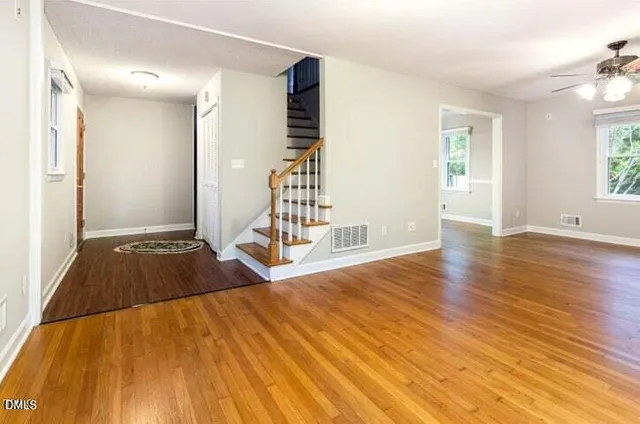 a view of a room with wooden floor and staircase