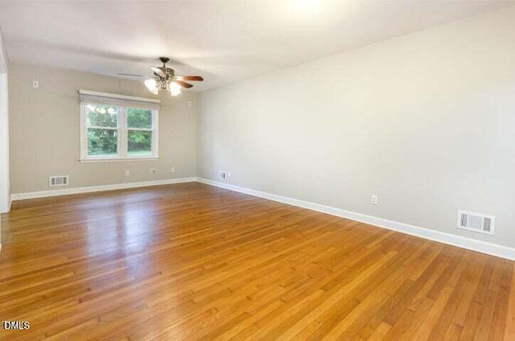 3209 Marie Drive Raleigh, NC 27604 - Photo 9 of 40 wooden floor in an empty room with a window
