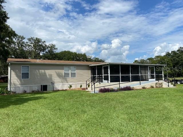 2505 Williams Road Plant City, FL 33565 - Photo 2 of 7 a view of a house with a big yard and a large tree
