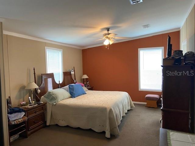 2505 Williams Road Plant City, FL 33565 - Photo 6 of 7 a bedroom with a bed and a chandelier