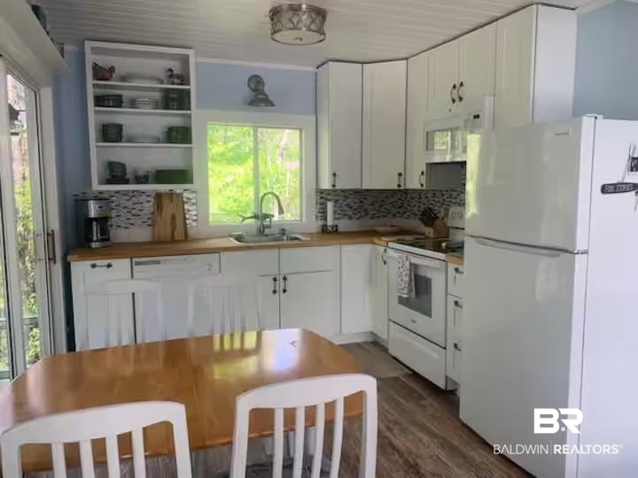 42090 Bayou Road Bay Minette, AL 36507 - Photo 4 of 13 Kitchen featuring white appliances, white cabinets, butcher block counters, and dark wood-style floors