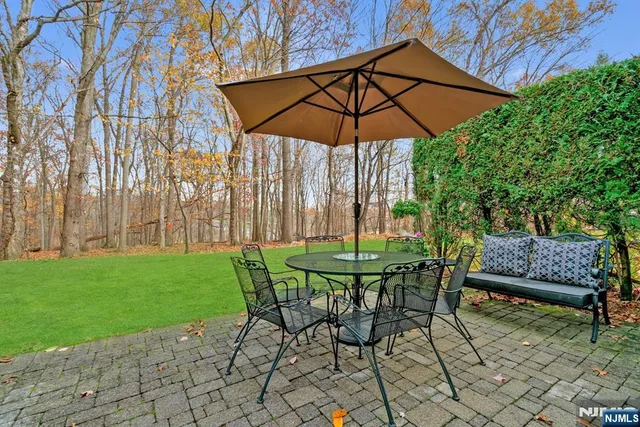 a view of table and chairs under an umbrella