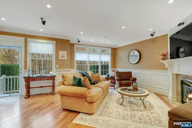 a living room with fireplace furniture and a large window