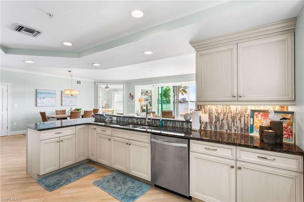 4975 Bonita Beach Road Southwest Bonita Springs, FL 34134 - Photo 14 of 49 Beautiful white wood, soft close cabinetry, under cabinetry lighting, custom tiled backsplash.
