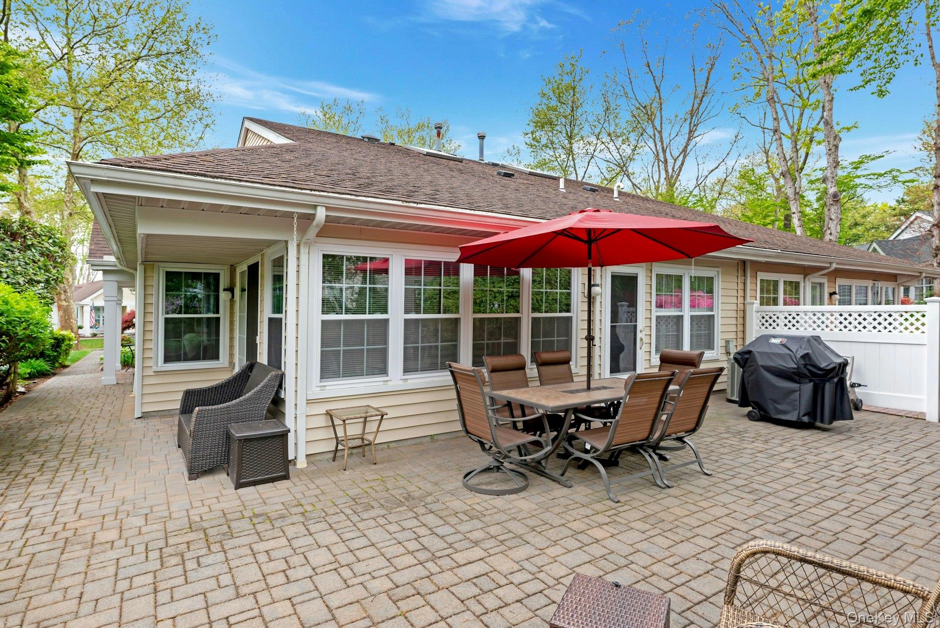 104 Glen Drive Ridge, NY 11961 - Photo 23 of 25 a view of a patio with a table and chairs under an umbrella