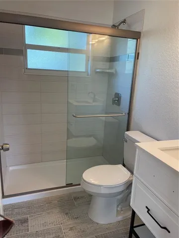 a white toilet sitting next to a bath tub and shower