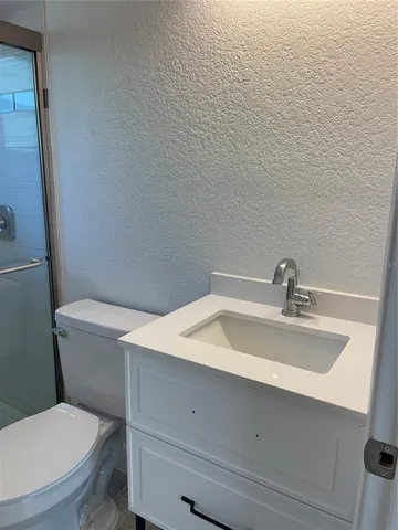 a bathroom with a sink a toilet and vanity