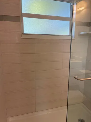 a bathroom with a glass door shower