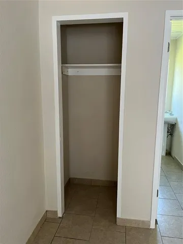 a white toilet sitting next to a window