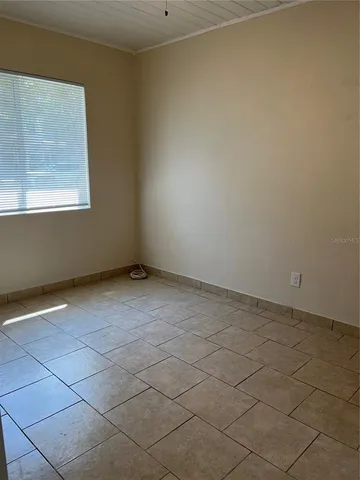 a view of an empty room with a window