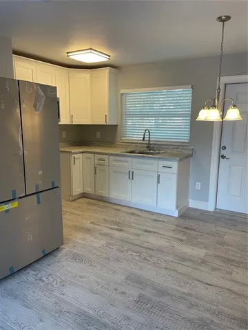 a kitchen with stainless steel appliances granite countertop a refrigerator a sink and a stove