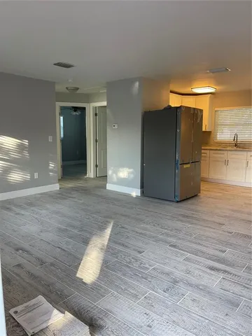 a view of a living room with wooden floor