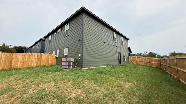 a view of a backyard with large trees