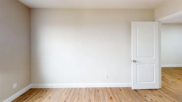 an empty room with wooden floor
