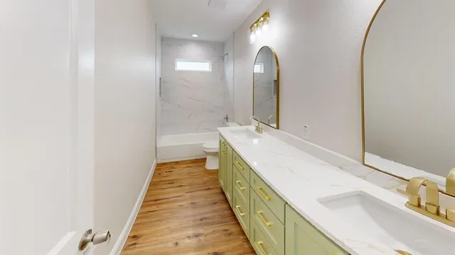 a spacious bathroom with a double vanity sink and mirror