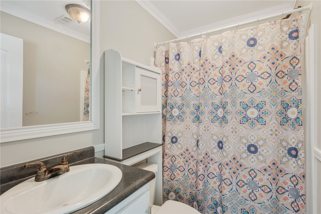 9144 Hensarling Lane Bryan, TX 77808 - Photo 12 of 25 a bathroom with a sink toilet and shower