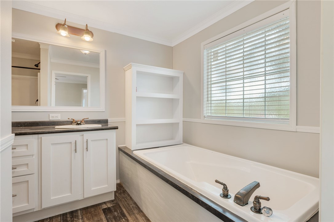 9144 Hensarling Lane Bryan, TX 77808 - Photo 16 of 25 a bathroom with a sink and a bathtub