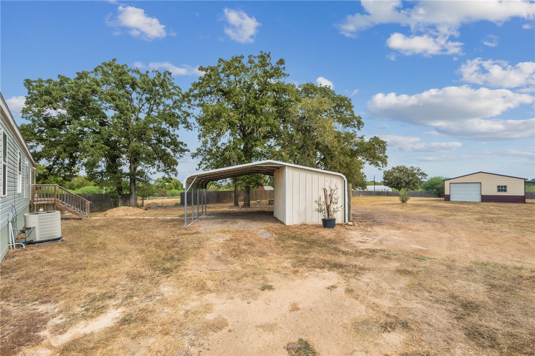 9144 Hensarling Lane Bryan, TX 77808 - Photo 19 of 25 a view of a tiny house with a yard