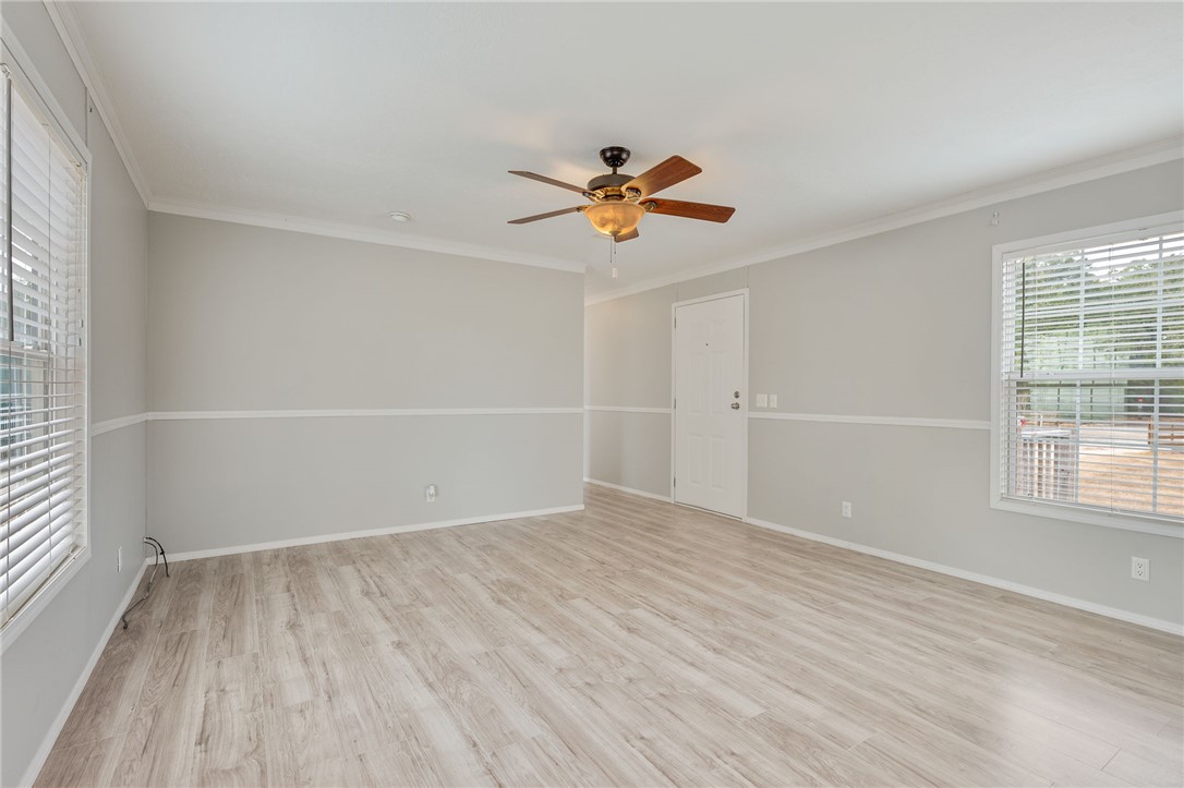 9144 Hensarling Lane Bryan, TX 77808 - Photo 5 of 25 wooden floor in an empty room with a window