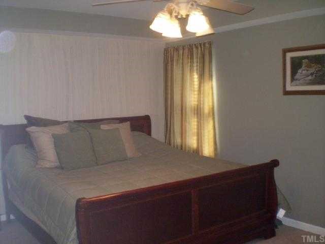 1135 Paynes Tavern Road Roxboro, NC 27574 - Photo 6 of 12 a bed sitting in a spacious bedroom next to a window