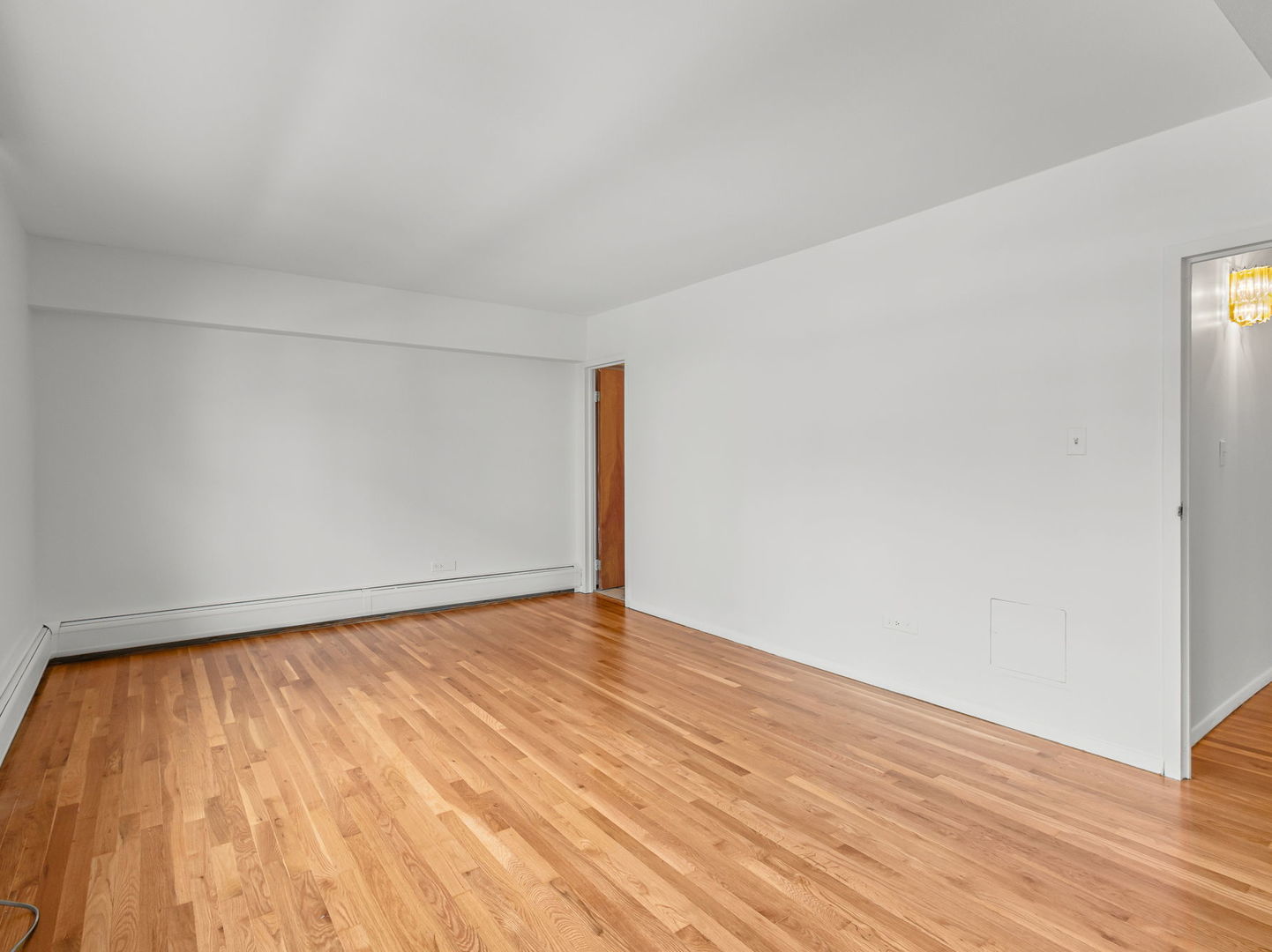 9009 Golf Road, Unit 2A Des Plaines, IL 60016 - Photo 10 of 18 a view of an empty room with wooden floor
