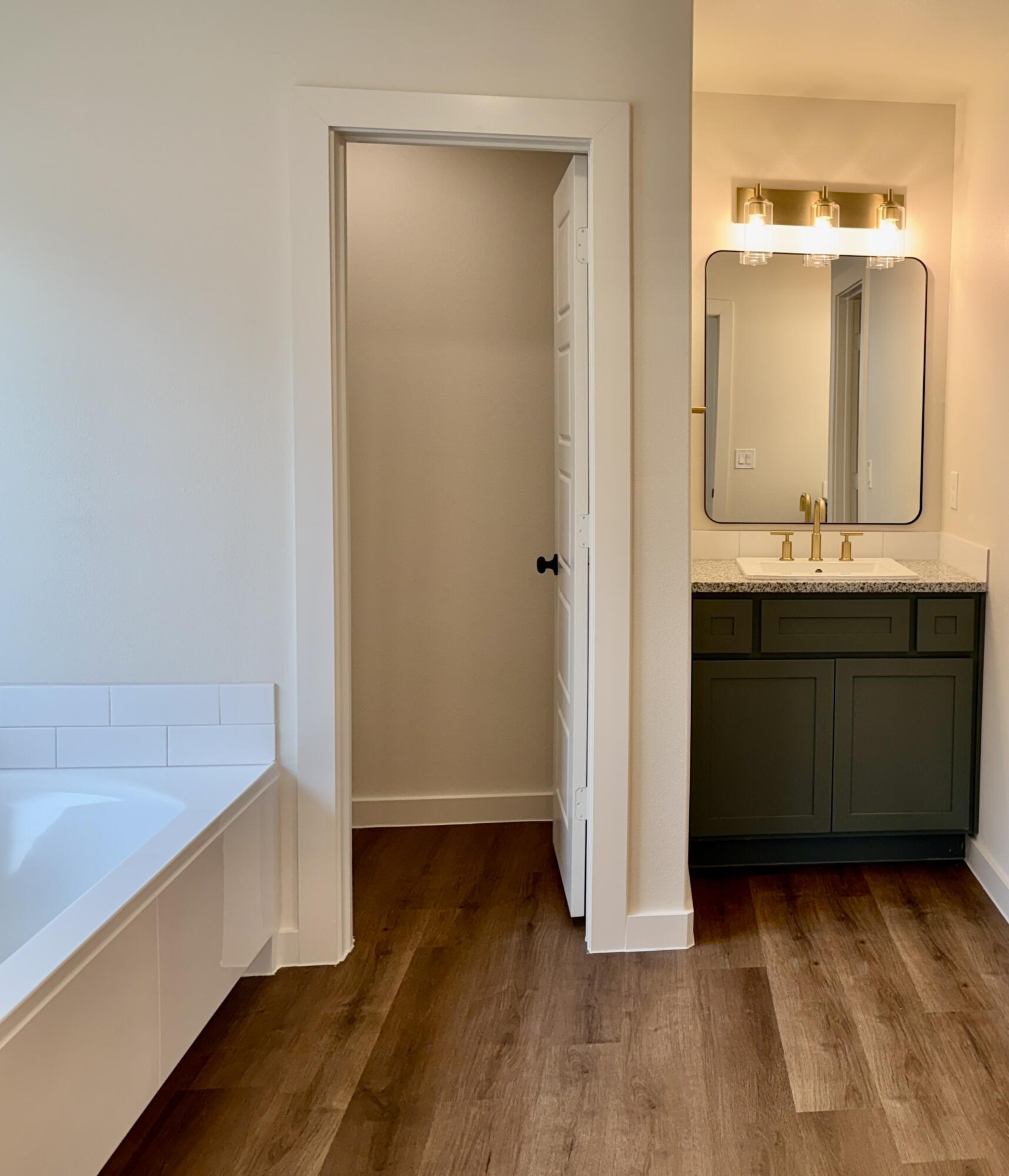 7007 16th Street Lubbock, TX 79416 - Photo 14 of 32 a view of bathroom with a sink and mirror