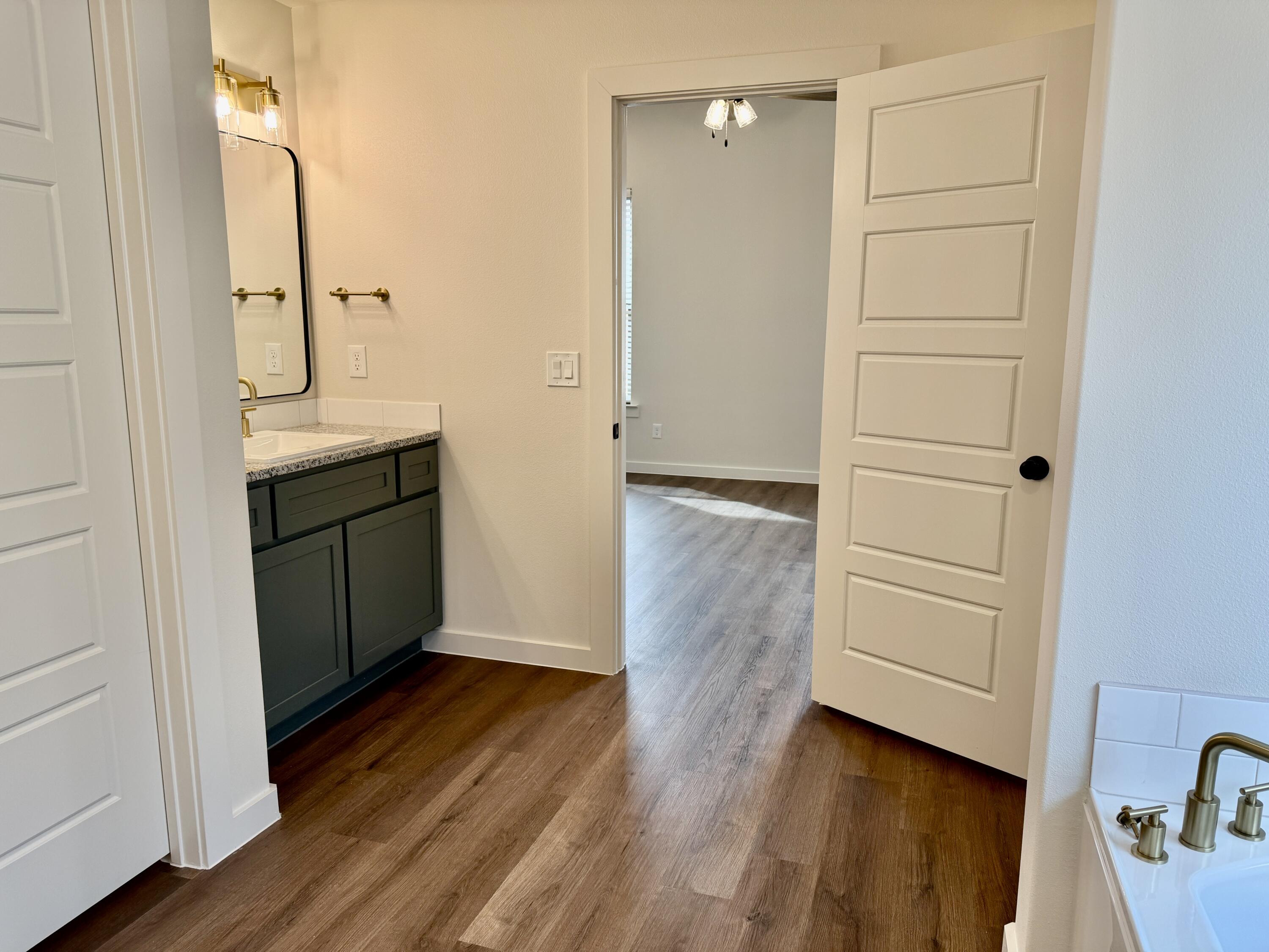 7007 16th Street Lubbock, TX 79416 - Photo 15 of 32 wooden floor in an empty room