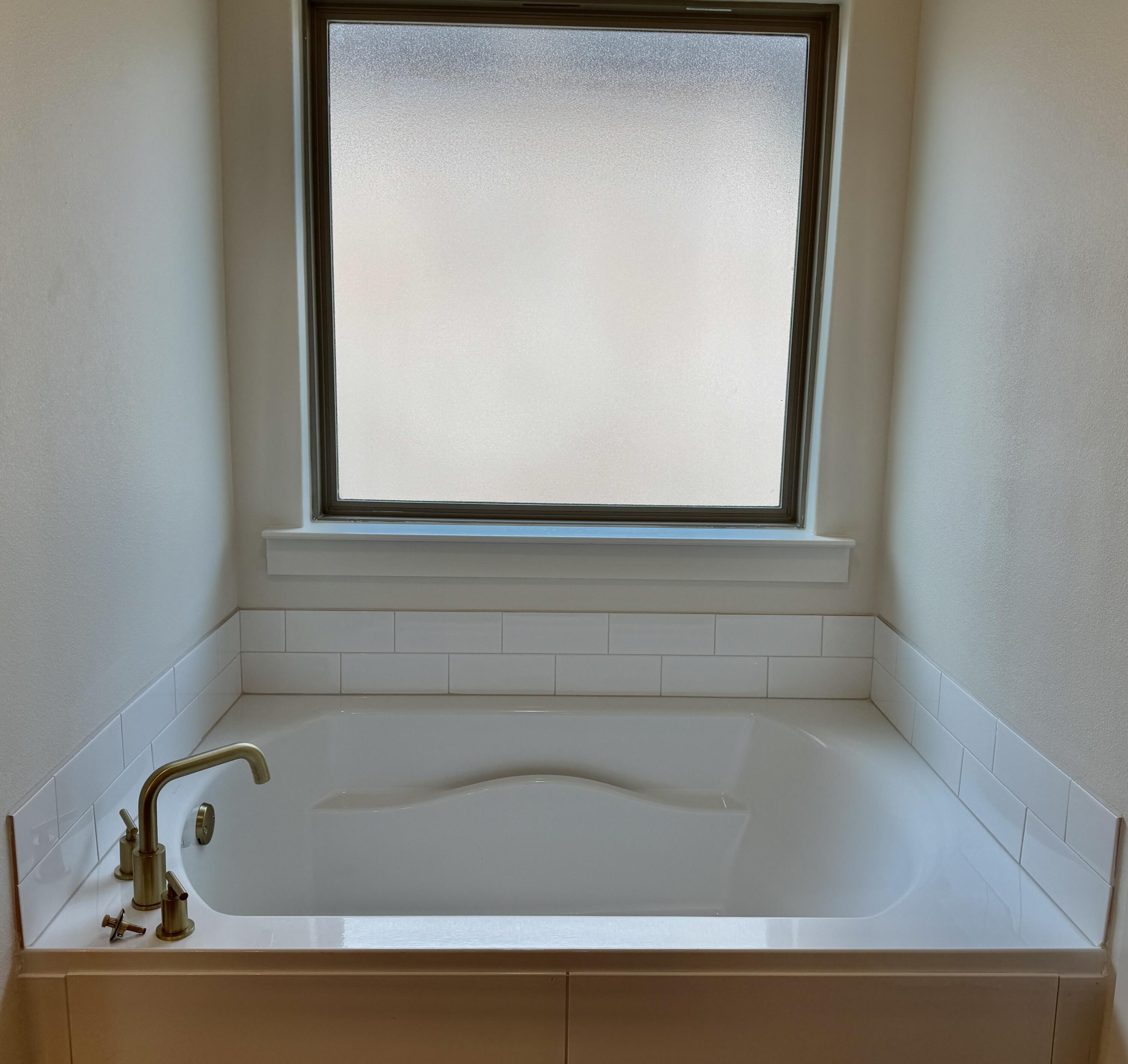 7007 16th Street Lubbock, TX 79416 - Photo 16 of 32 a bathroom with a bathtub