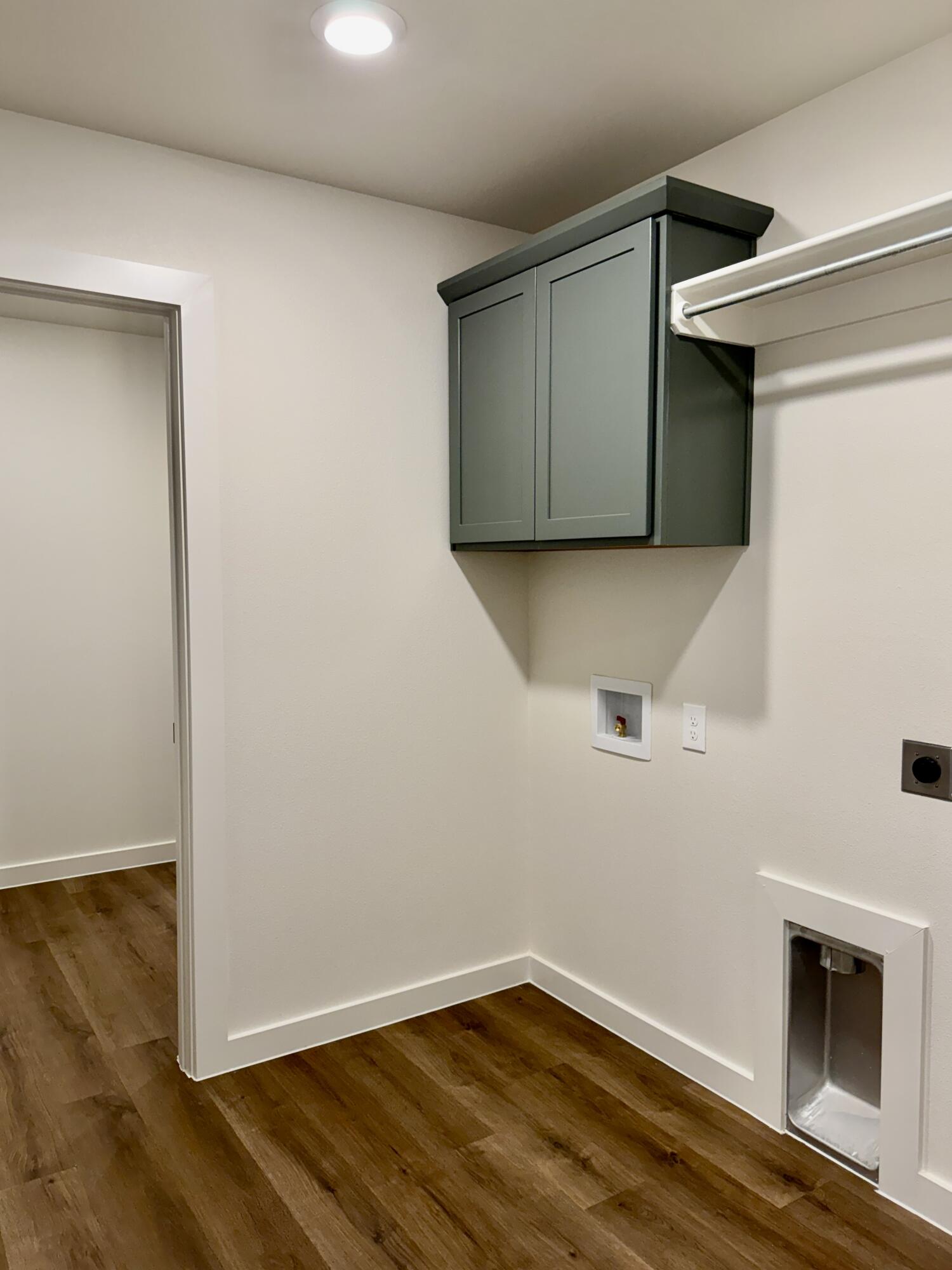 7007 16th Street Lubbock, TX 79416 - Photo 19 of 32 a view of an empty room with wooden floor and a window