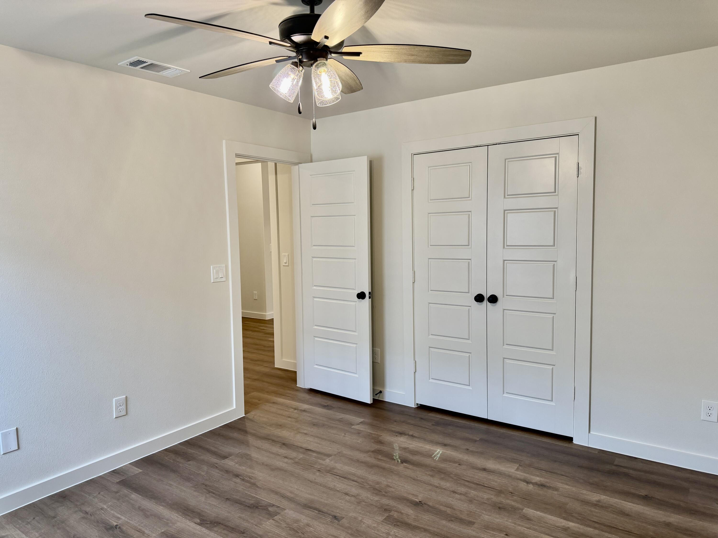 7007 16th Street Lubbock, TX 79416 - Photo 25 of 32 an empty room with wooden floor closet and fan